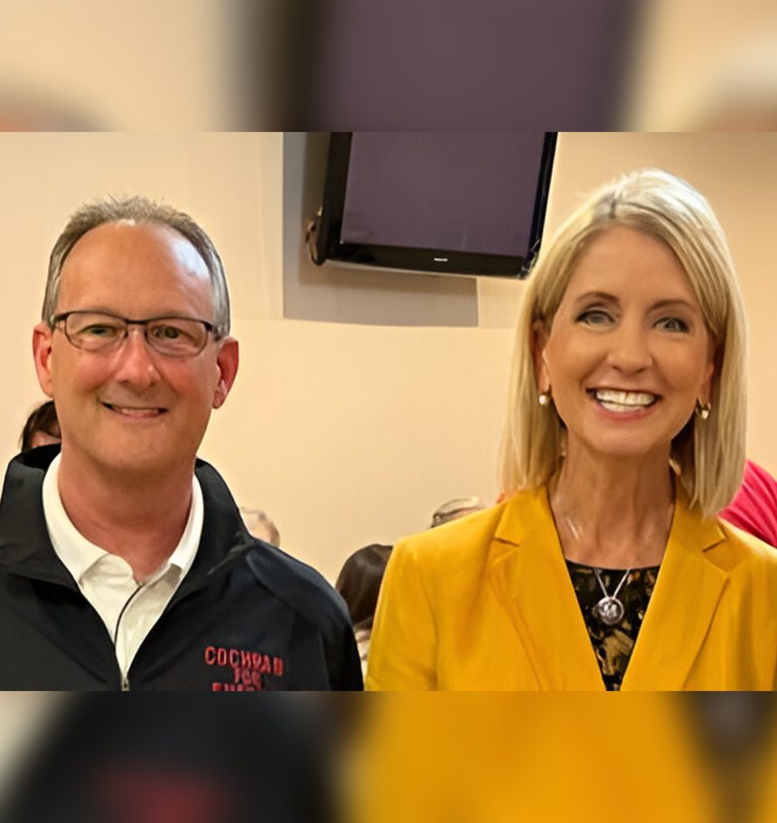 A man and woman smile for the camera.